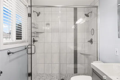 a bathroom with a shower and toilet