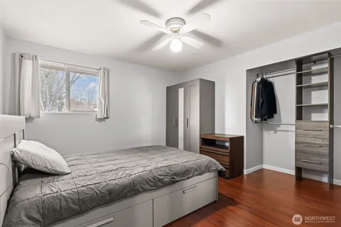 a bedroom with a large bed and a chandelier