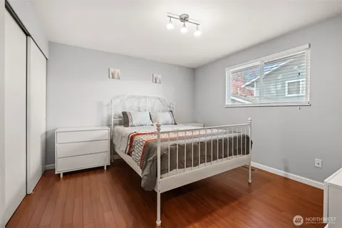 a bedroom with a bed and a ceiling fan
