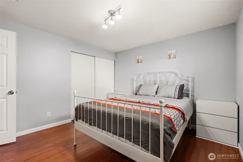 a bedroom with a bed and a flat screen tv