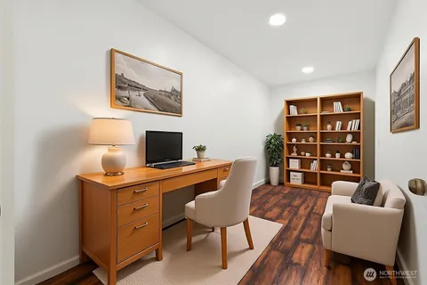 a view of a workspace with furniture and wooden floor