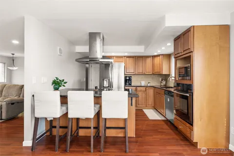 a view of a dining room with furniture kitchen and wooden floor