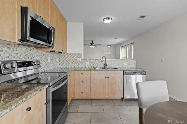 a kitchen with a sink stove and microwave