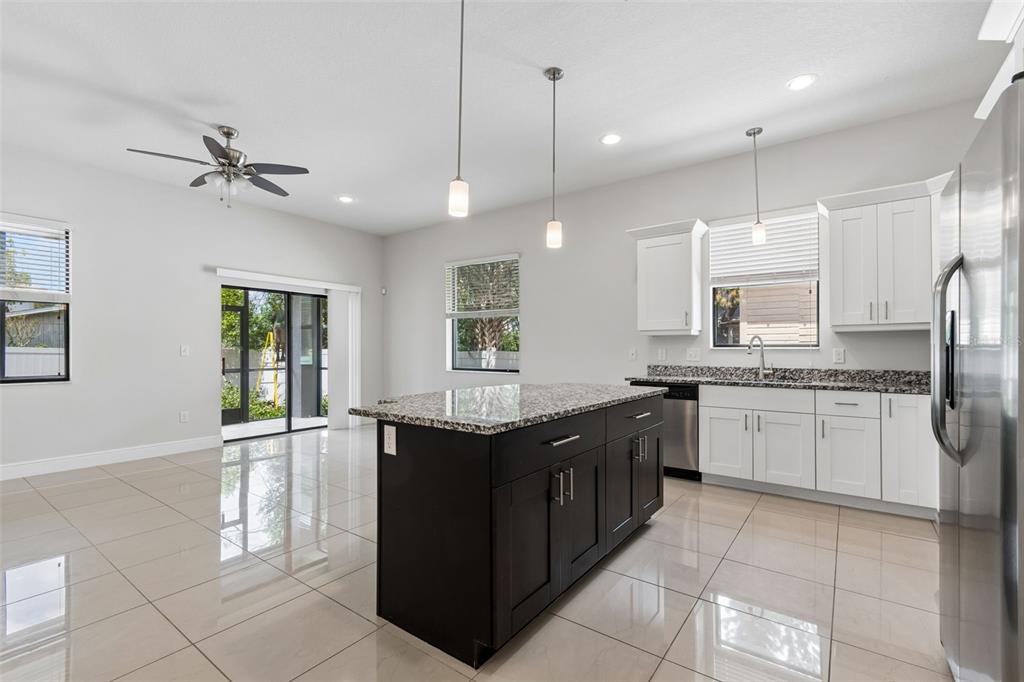 2311 West Aileen Street Tampa, FL 33607 - Photo 12 of 38 a large kitchen with a stove a sink dishwasher and a refrigerator
