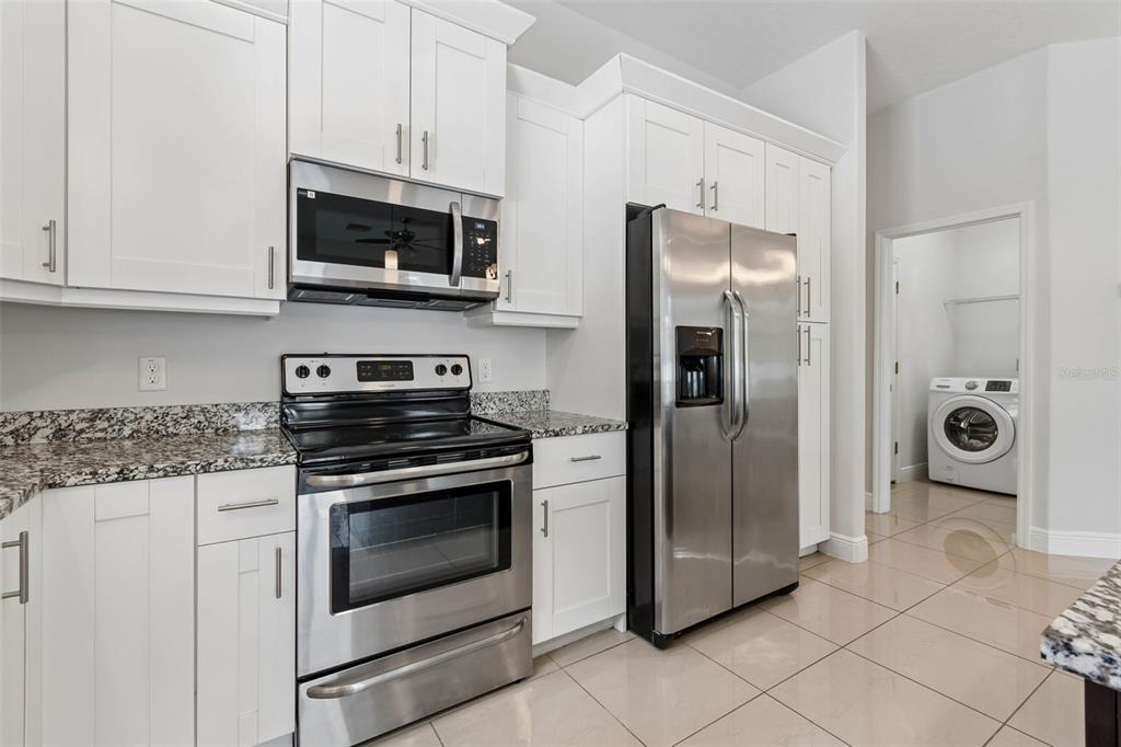 2311 West Aileen Street Tampa, FL 33607 - Photo 14 of 38 a kitchen with stainless steel appliances granite countertop a stove a microwave and a refrigerator