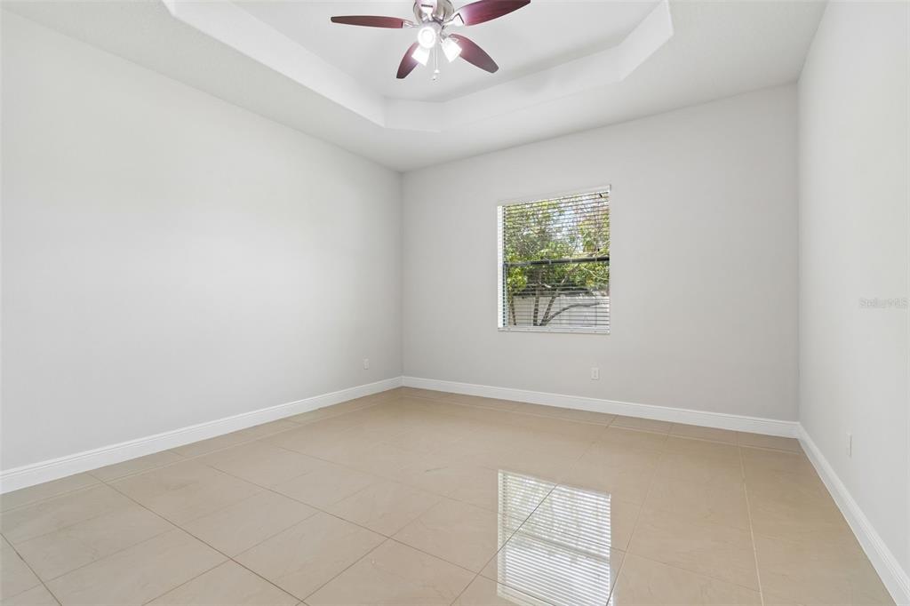 2311 West Aileen Street Tampa, FL 33607 - Photo 21 of 38 an empty room with a window and a ceiling fan