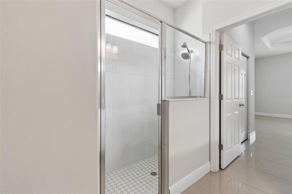 2311 West Aileen Street Tampa, FL 33607 - Photo 27 of 38 a bathroom with a glass shower door