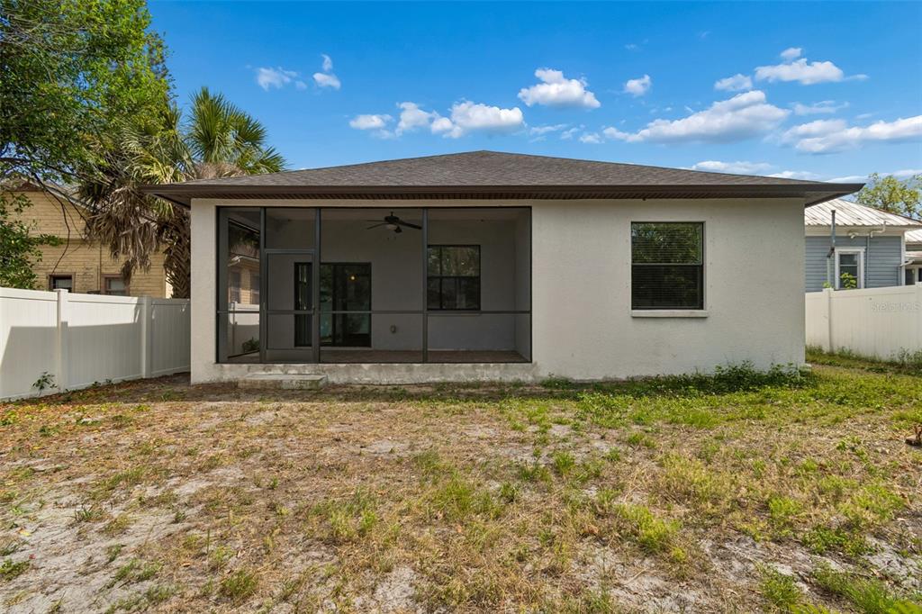 2311 West Aileen Street Tampa, FL 33607 - Photo 32 of 38 a view of yellow house with a yard