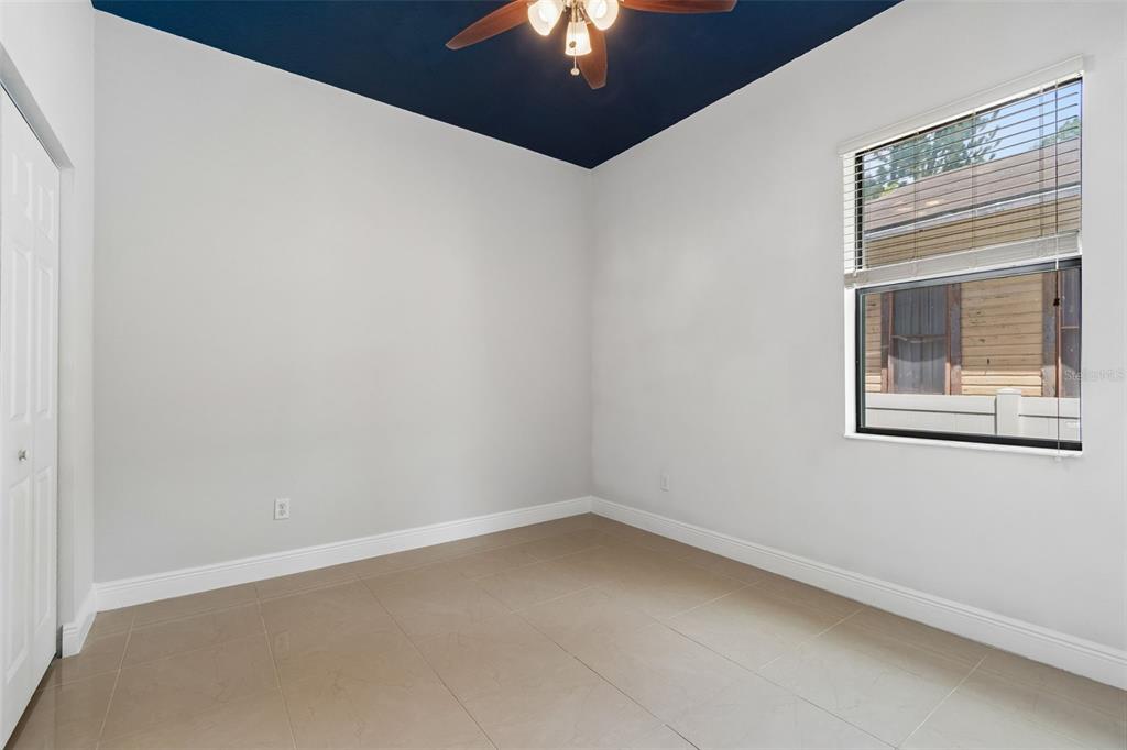 2311 West Aileen Street Tampa, FL 33607 - Photo 9 of 38 a view of an empty room with chandelier fan and wooden floor