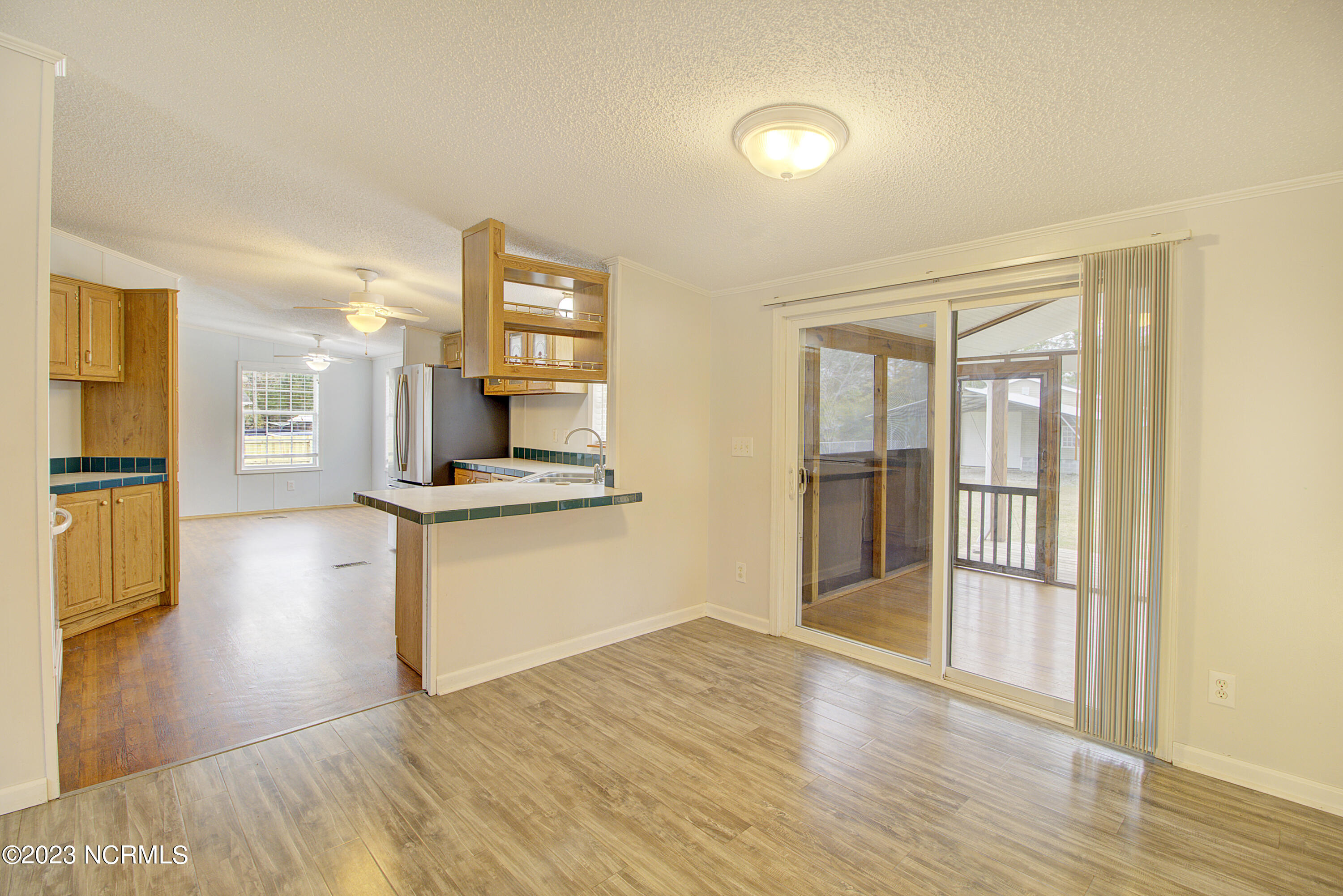 531 Greenacres Drive Hampstead, NC 28443 - Photo 8 of 45 Living to Kitchen and porch