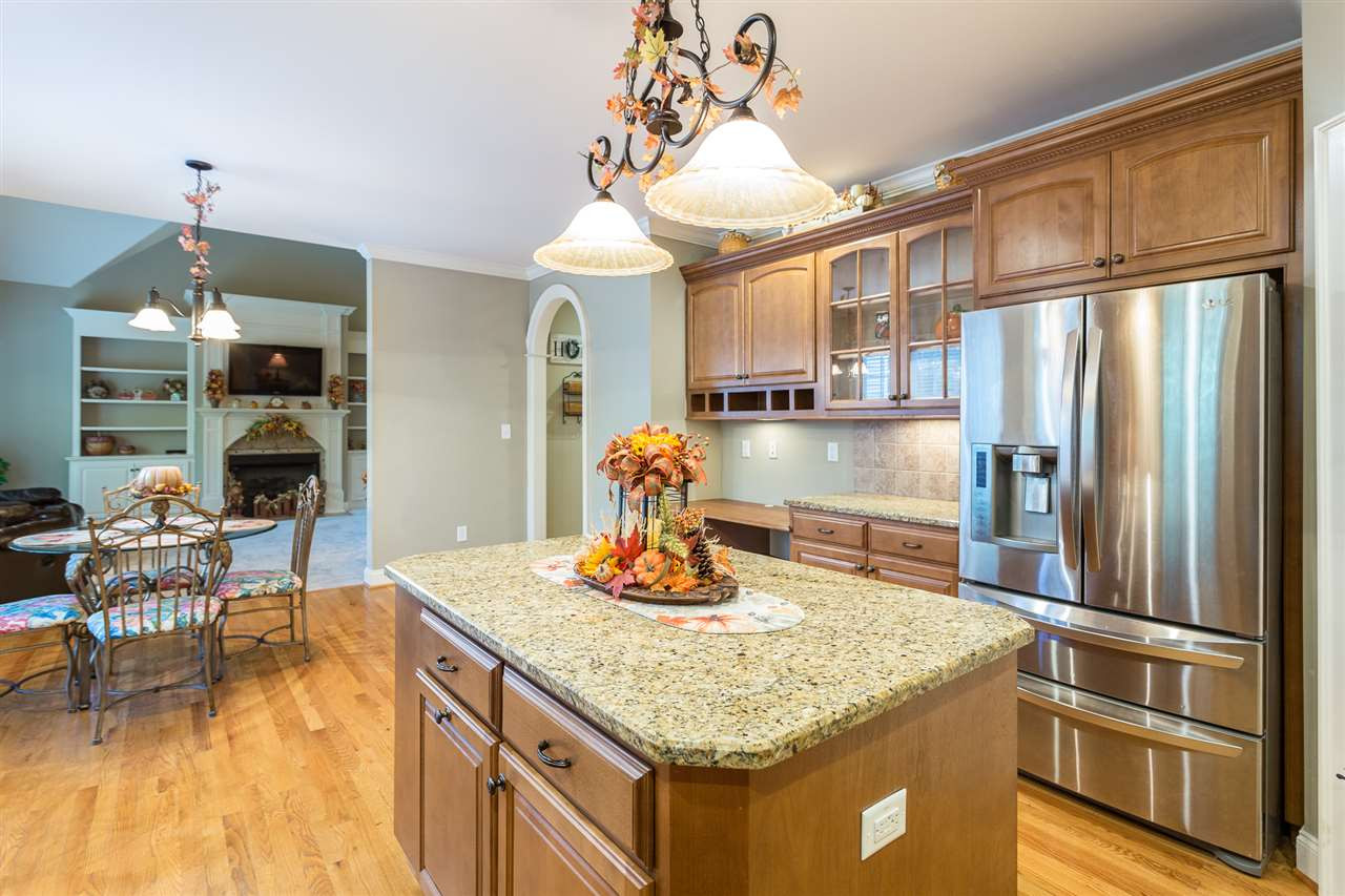 12 Vista Ridge Drive Willow Spring, NC 27592 - Photo 13 of 30 This gourmet island kitchen is a chef's delight & boasts granite counter-tops, tile backsplash & hdwd floors. The stainless steel appliance package includes a built-in microwave, dishwasher, smooth-top electric range w/self-cleaning oven & a refrigerator. Kitchen