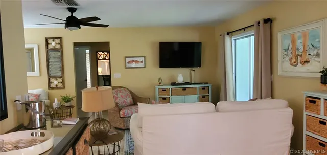 a living room with furniture a dining table and kitchen view