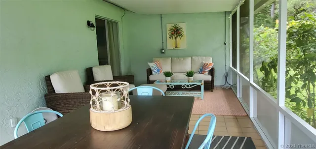 a outdoor dining space with furniture and potted plants