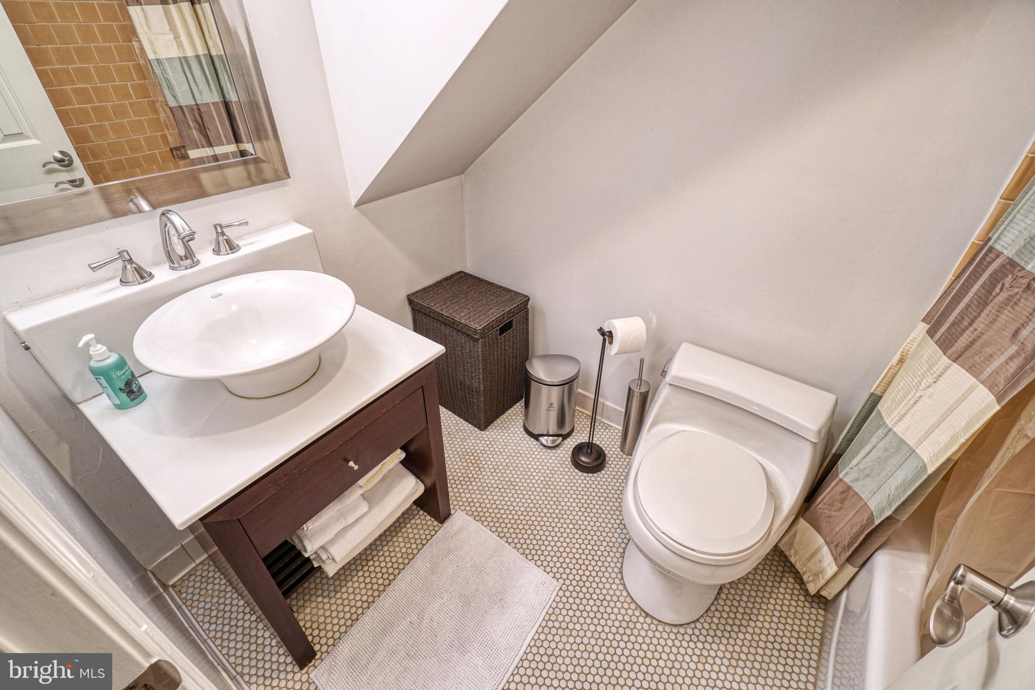 936 T Street Northwest, Unit B Washington, DC 20001 - Photo 11 of 19 a bathroom with a sink toilet a mirror and vanity