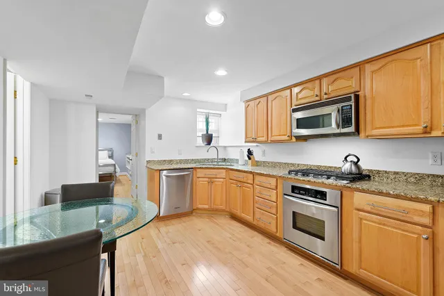 a kitchen with sink cabinets and dining table