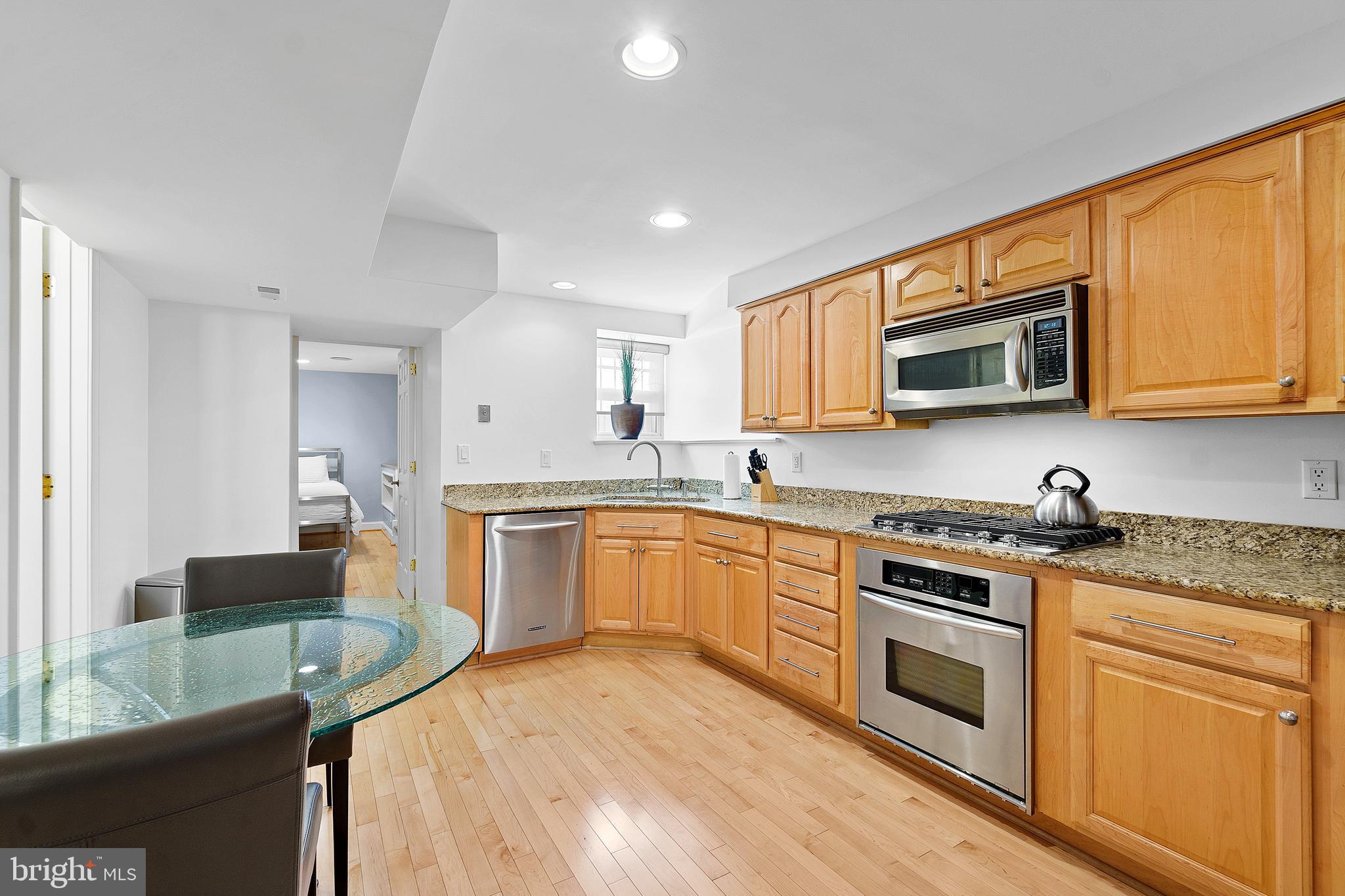 936 T Street Northwest, Unit B Washington, DC 20001 - Photo 8 of 19 a kitchen with stainless steel appliances granite countertop a sink stove microwave and cabinets