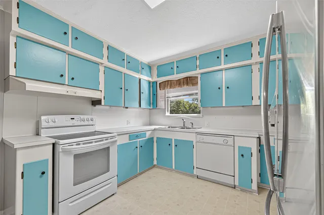 a kitchen with a refrigerator and a sink