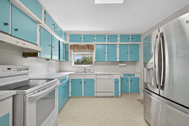 a utility room with cabinets a washer and dryer