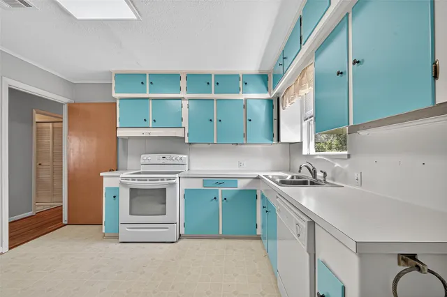 a view of kitchen and an empty room