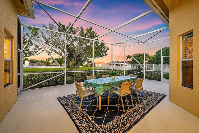 a view of a patio with a table chairs and a backyard