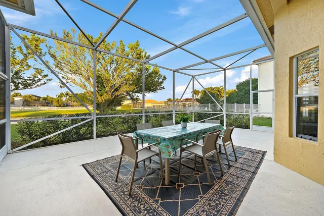 a view of a patio with a table chairs and backyard