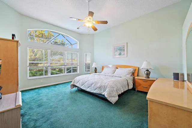 a spacious bedroom with a bed and a large window