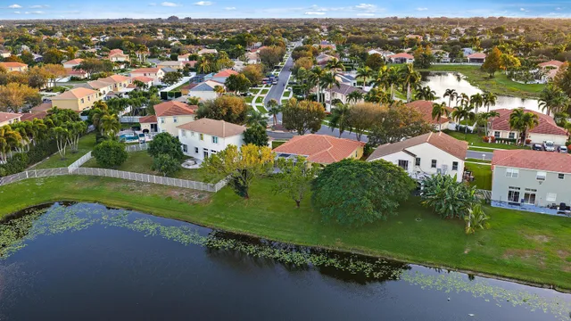 an aerial view of residential houses with outdoor space and river