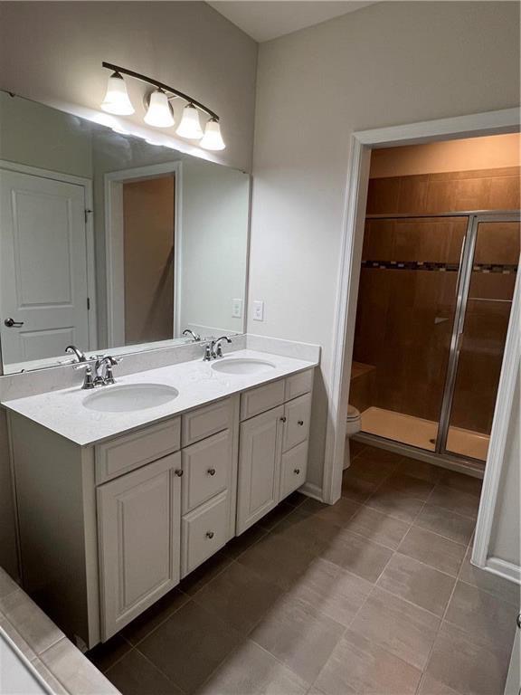 2356 Raya Way Easton, PA 18045 - Photo 15 of 28 A classic double vanity with stone counters complements the spacious tile flooring.