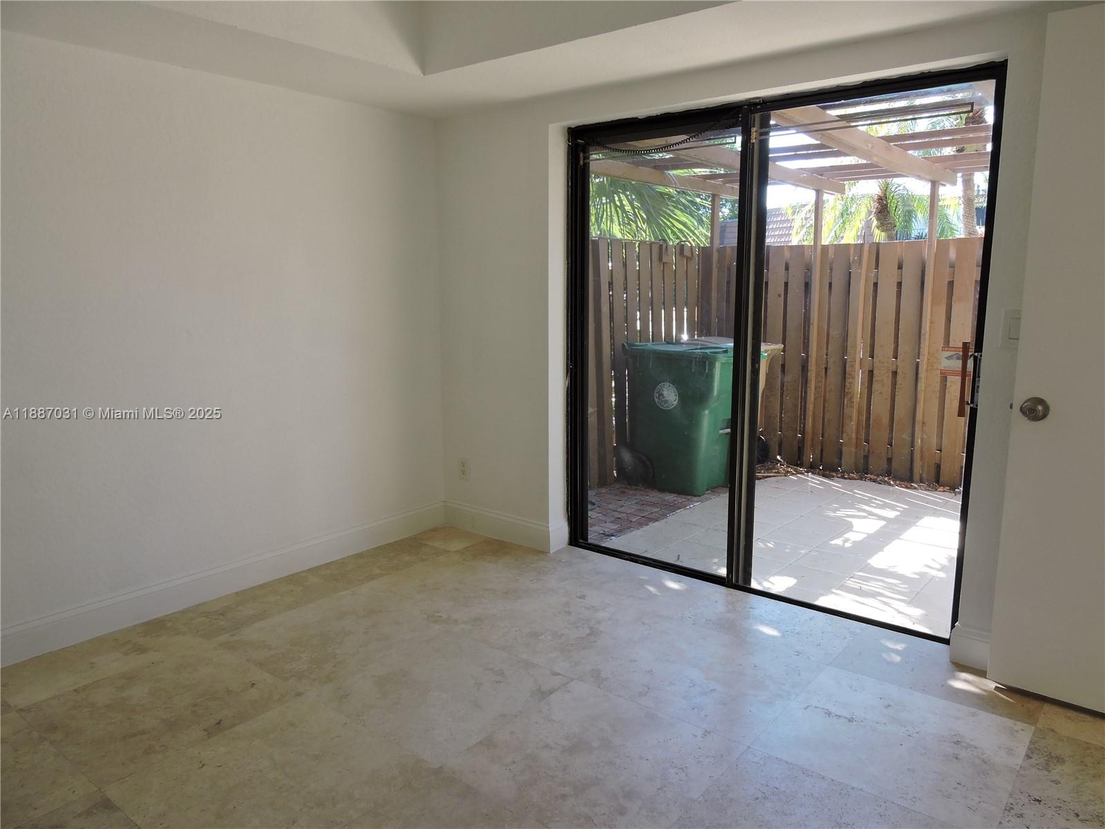 1316 Southwest 118th Terrace, Unit 1316 Davie, FL 33325 - Photo 21 of 44 an empty room with sliding glass door and shower