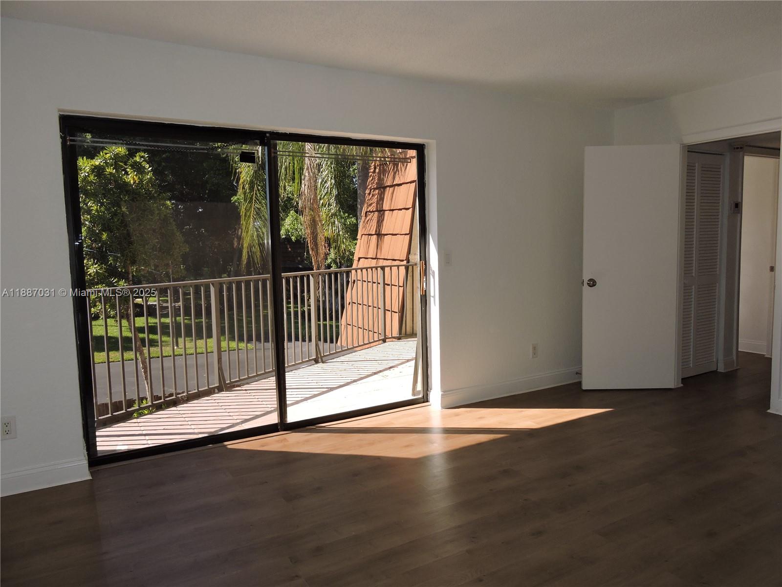 1316 Southwest 118th Terrace, Unit 1316 Davie, FL 33325 - Photo 25 of 44 a view of a room with wooden floor and a window