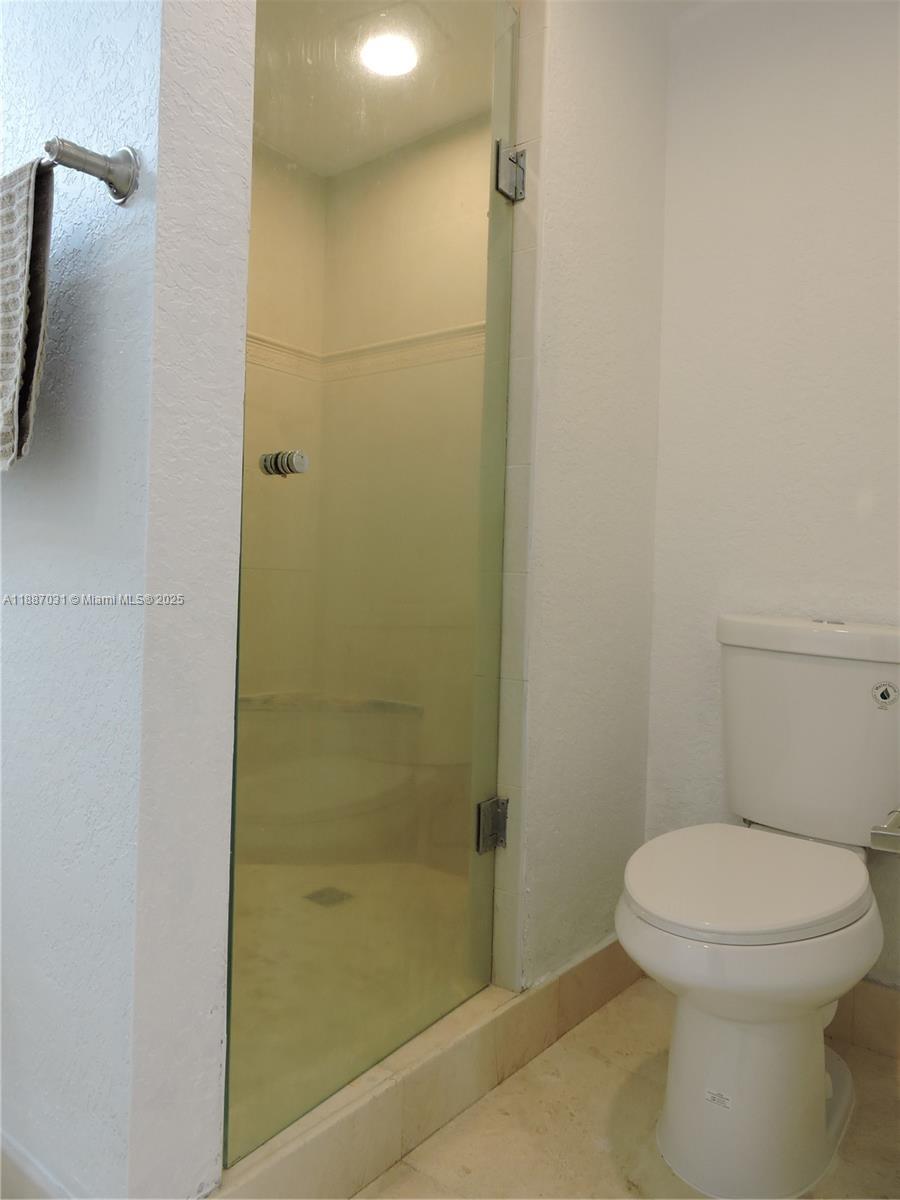 1316 Southwest 118th Terrace, Unit 1316 Davie, FL 33325 - Photo 31 of 44 a bathroom with a toilet and a shower