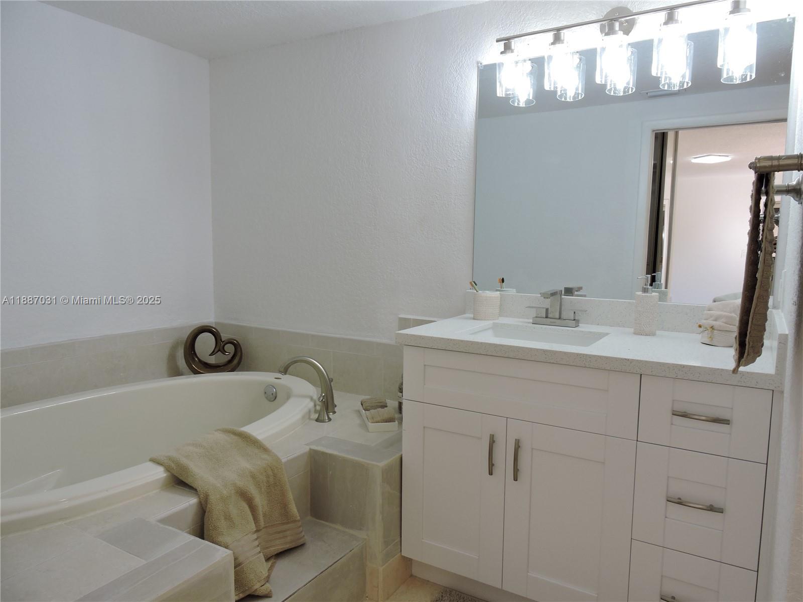 1316 Southwest 118th Terrace, Unit 1316 Davie, FL 33325 - Photo 32 of 44 a bathroom with a sink and a mirror