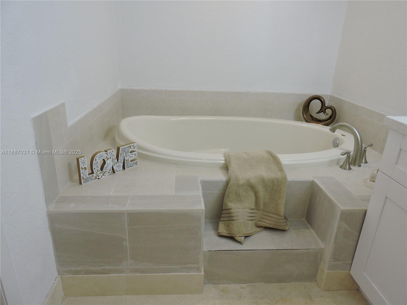 1316 Southwest 118th Terrace, Unit 1316 Davie, FL 33325 - Photo 35 of 44 a bathroom with a bathtub