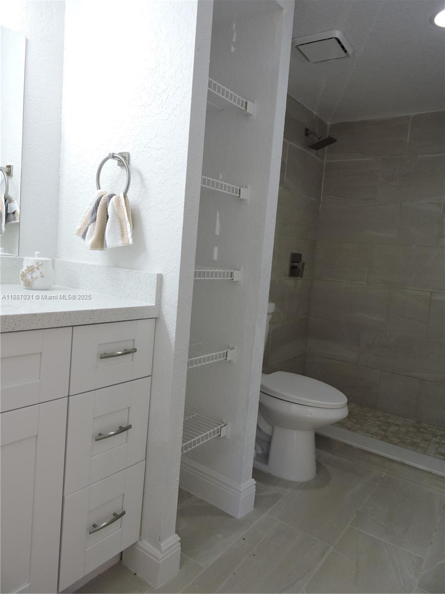 1316 Southwest 118th Terrace, Unit 1316 Davie, FL 33325 - Photo 41 of 44 a bathroom with a toilet sink and vanity
