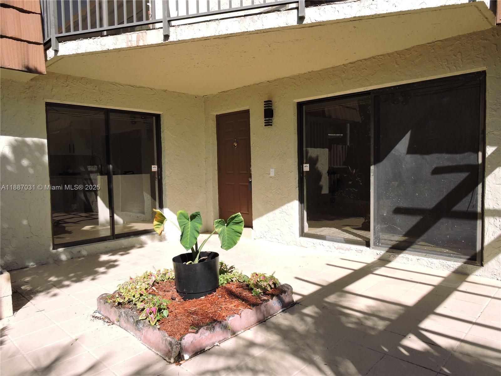 1316 Southwest 118th Terrace, Unit 1316 Davie, FL 33325 - Photo 5 of 44 a view of a entryway door front of house