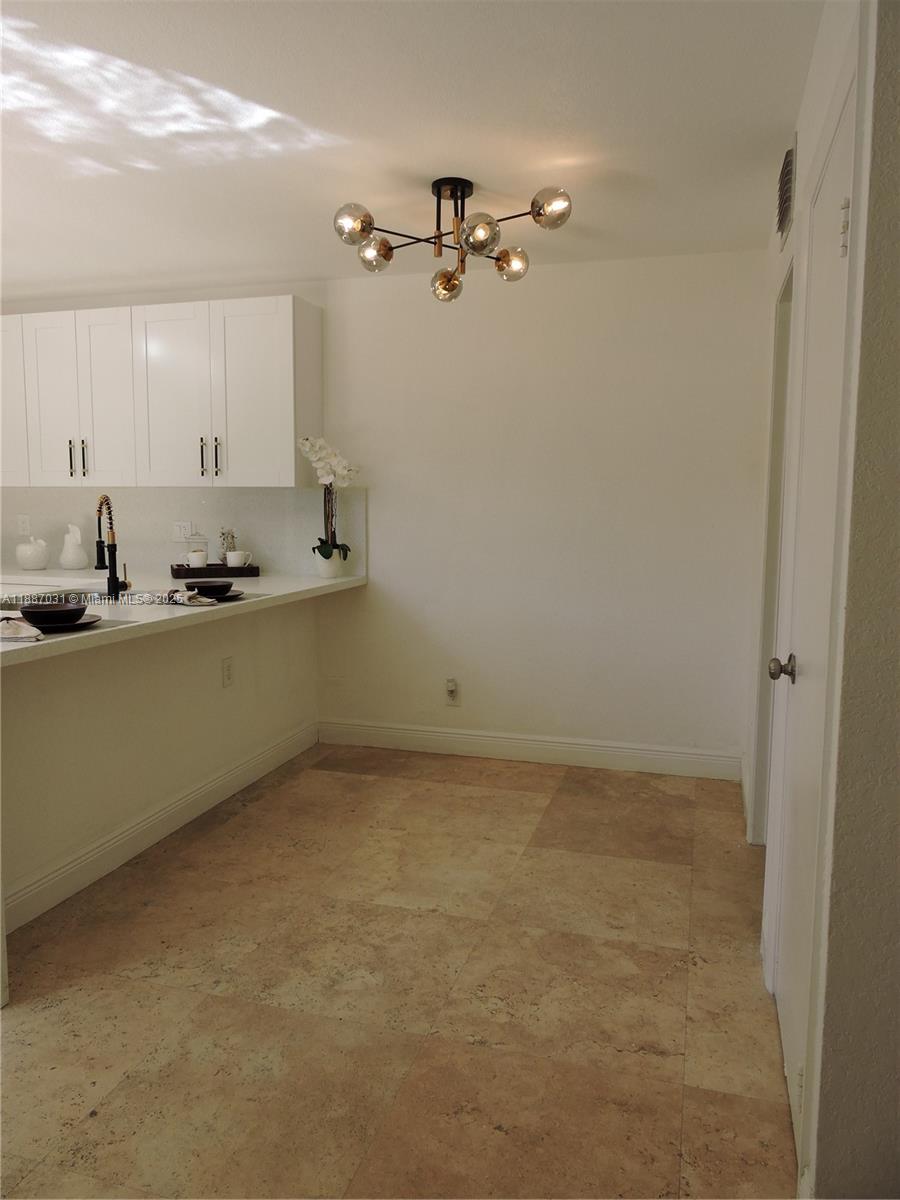 1316 Southwest 118th Terrace, Unit 1316 Davie, FL 33325 - Photo 7 of 44 a kitchen with a sink and cabinets