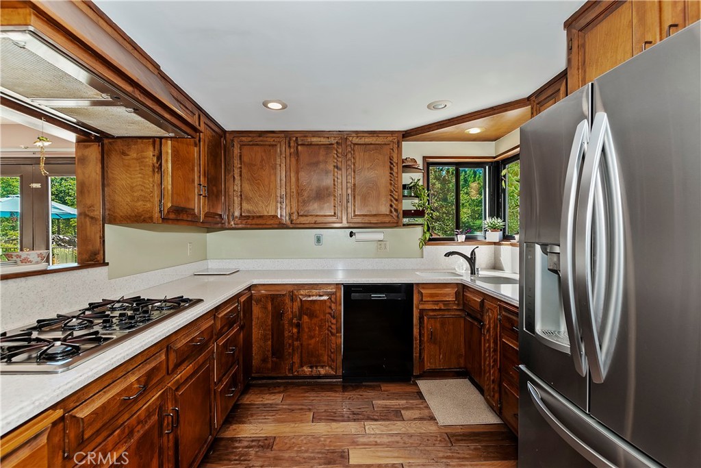 23167 Brookside Road Crestline, CA 92325 - Photo 21 of 49 a kitchen with stainless steel appliances granite countertop a sink stove and refrigerator