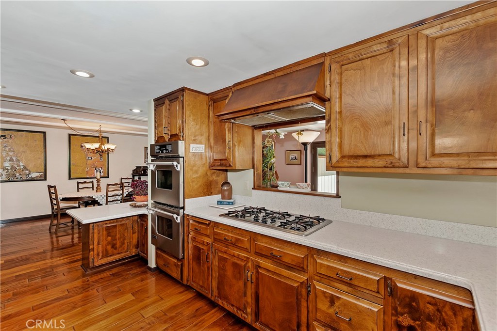 23167 Brookside Road Crestline, CA 92325 - Photo 23 of 49 a kitchen with stainless steel appliances kitchen island granite countertop a stove a sink and dishwasher wooden cabinets with granite countertops