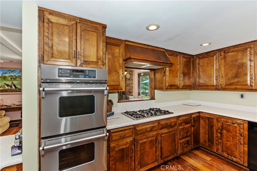 23167 Brookside Road Crestline, CA 92325 - Photo 24 of 49 a kitchen with granite countertop cabinets stainless steel appliances and a counter space