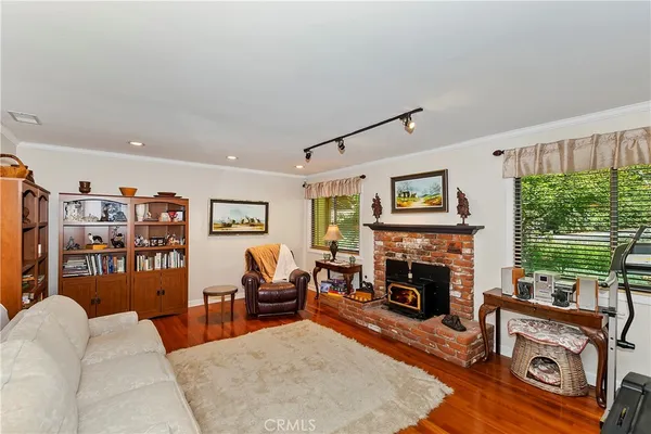 a living room with furniture a window and a fireplace