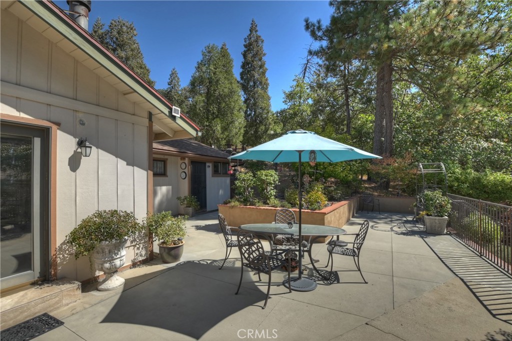 23167 Brookside Road Crestline, CA 92325 - Photo 35 of 49 a patio with a patio table and chairs