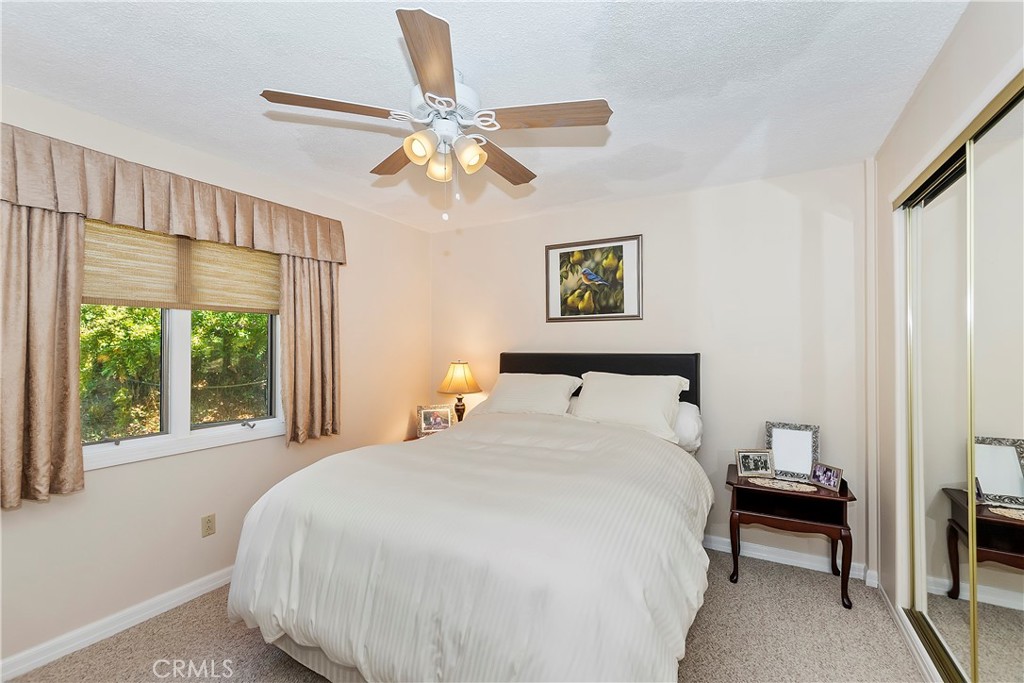 23167 Brookside Road Crestline, CA 92325 - Photo 46 of 49 a bedroom with a large bed and a chandelier