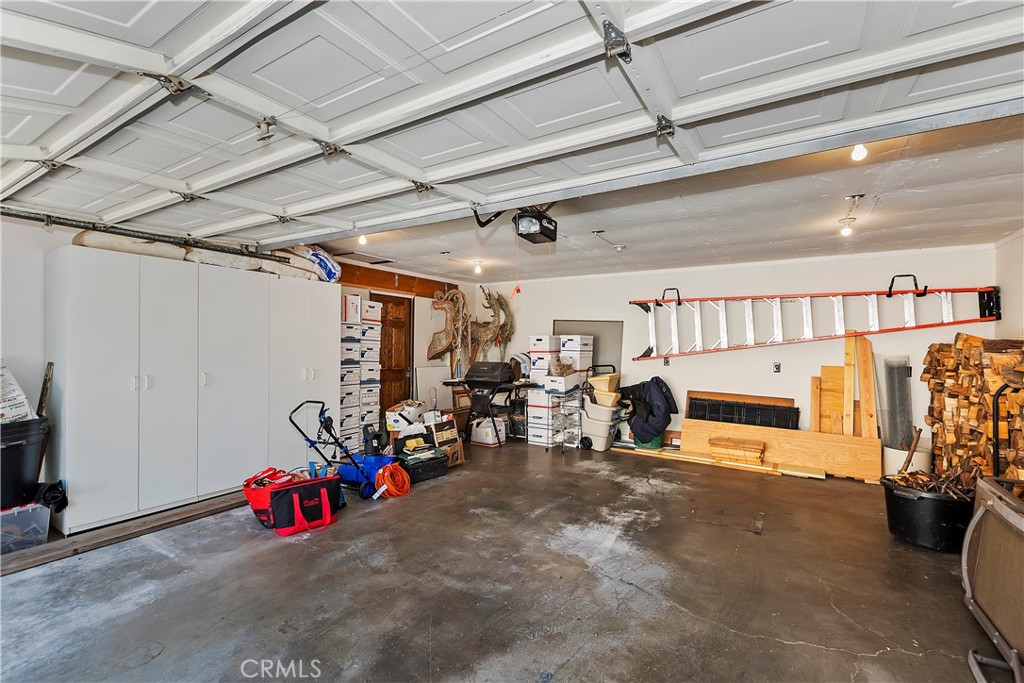 23167 Brookside Road Crestline, CA 92325 - Photo 49 of 49 a view of a garage with a bike and white walls