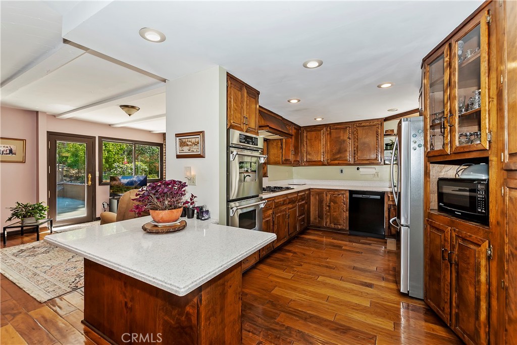 23167 Brookside Road Crestline, CA 92325 - Photo 5 of 49 a kitchen with a stove a refrigerator and a dining table