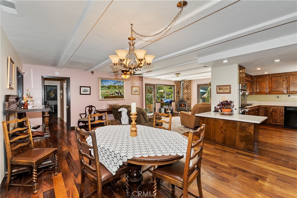 23167 Brookside Road Crestline, CA 92325 - Photo 6 of 49 a view of a dining room with furniture a chandelier and wooden floor