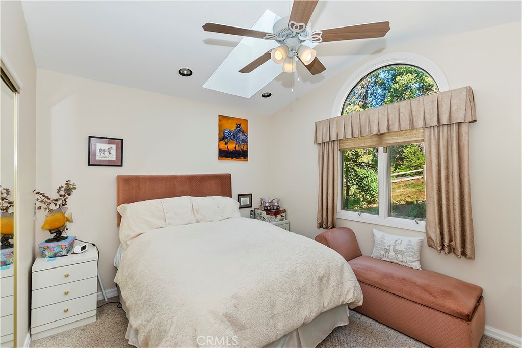 23167 Brookside Road Crestline, CA 92325 - Photo 10 of 49 a bedroom with a bed and a large window