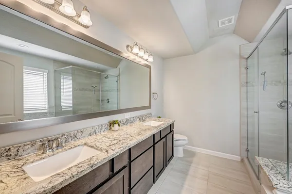 a bathroom with a tub a sink and shower