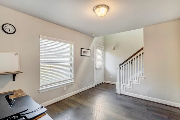 a view of a workspace with furniture and wooden floor