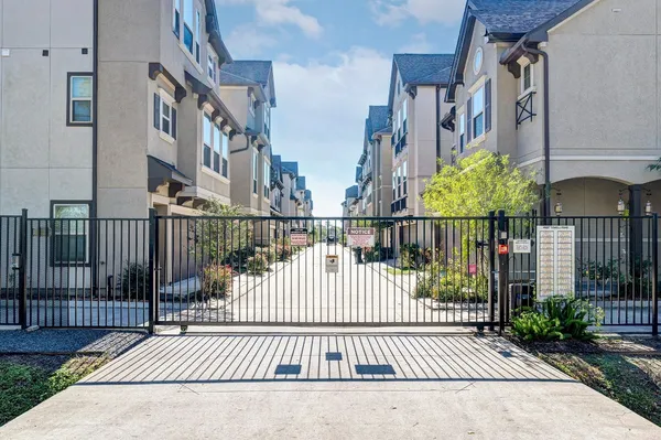 a view of an house with backyard and a tree
