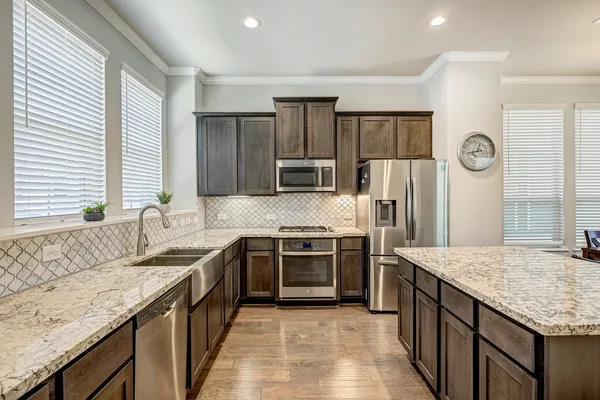 an open kitchen with a table and chairs